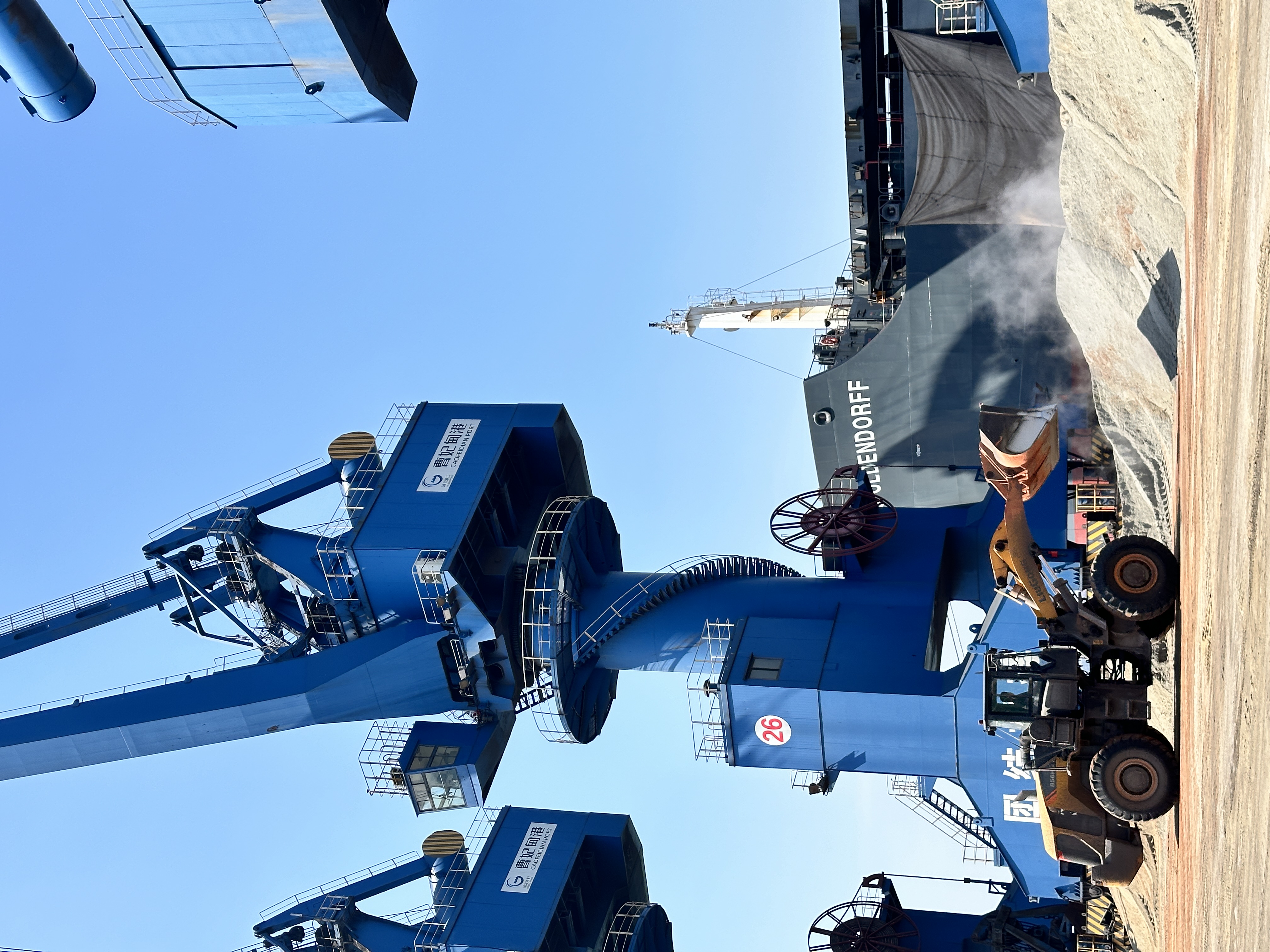 Operational dry bulk transfer and port-handling scene reflecting cargo execution discipline