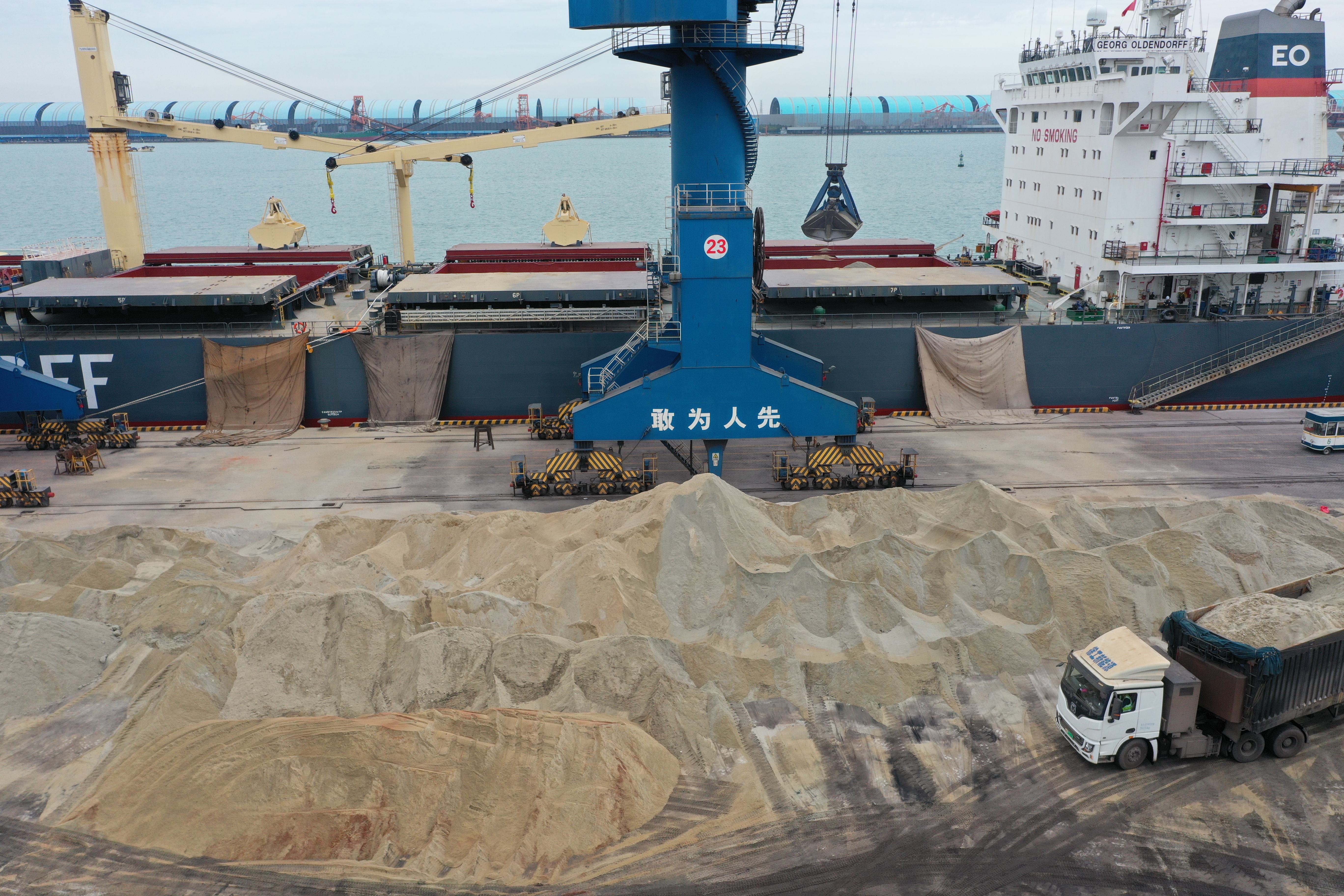 Bulk material loading operation at an industrial port