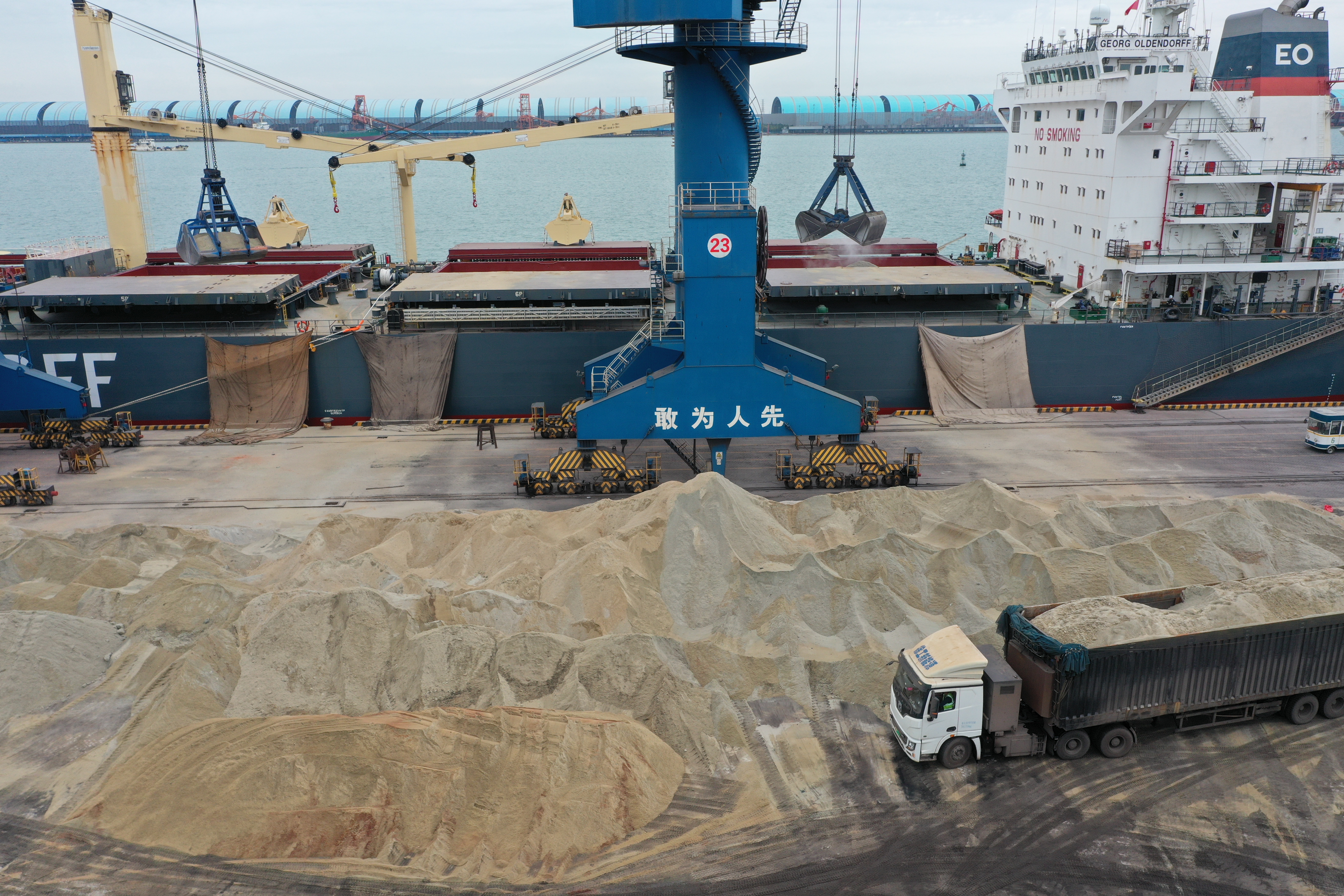 Port loading operations illustrating how bulk material trade responds to supply shifts